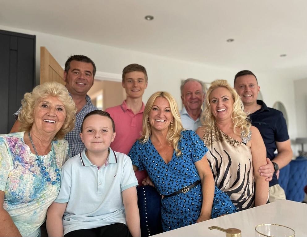 Sylvia, her daughters and extended family smile